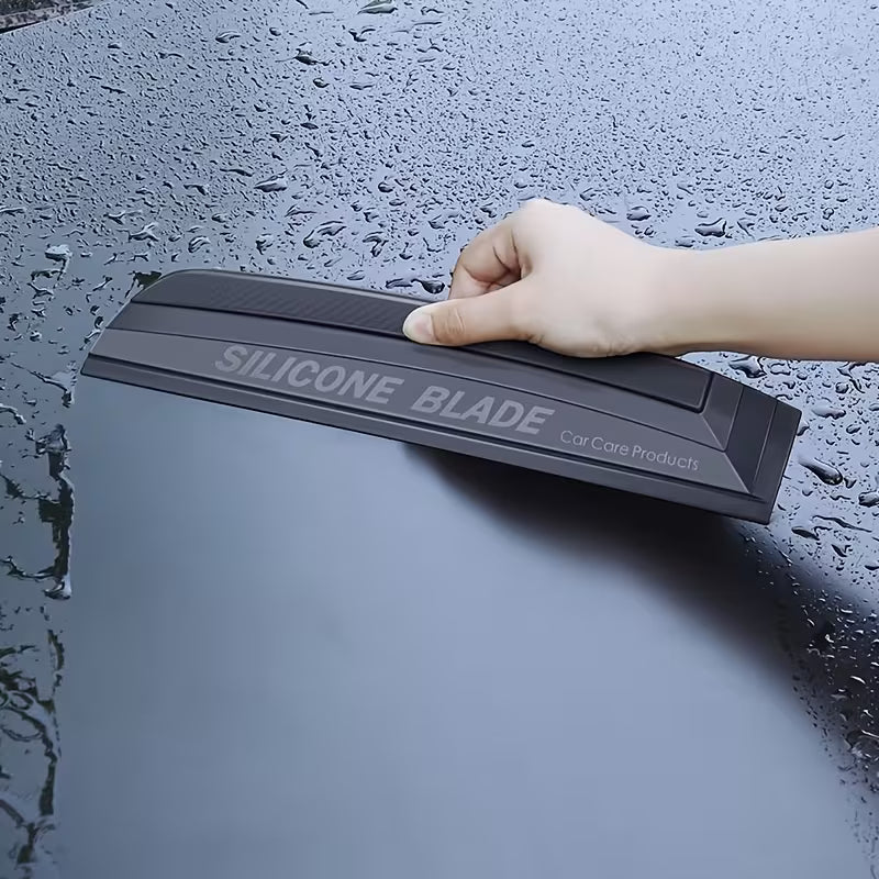Silicone blade being used on a wet car surface
